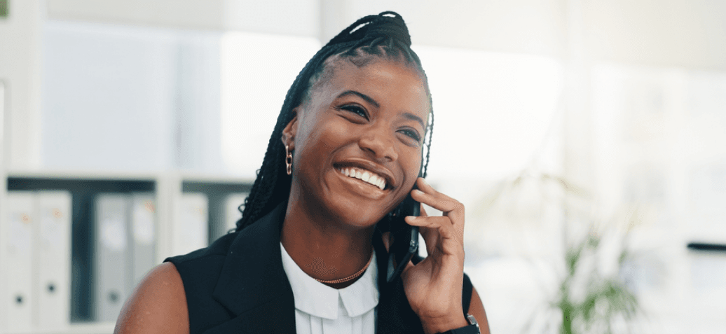 A woman smiling as she takes a call